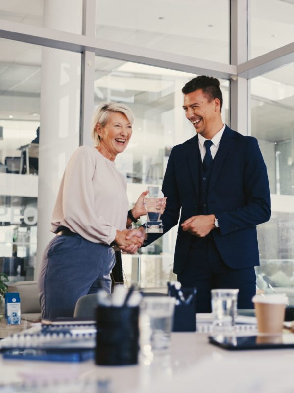 Applause, success and award with business people in meeting for trophy, achievement and deal. Promotion, congratulation and handshake with group of employees in office for profit, bonus and winner.