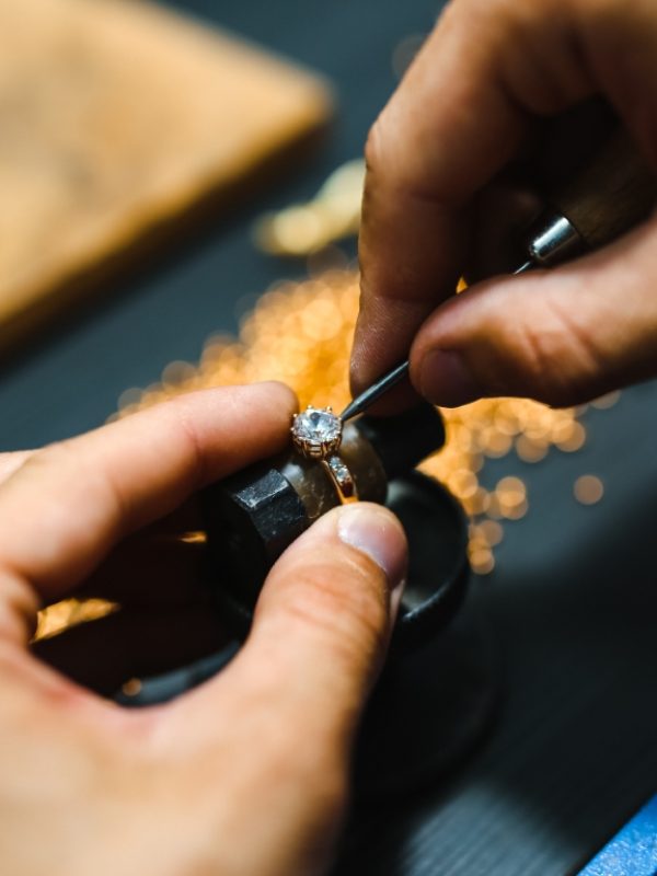 Master goldsmith working at golden ring.  Jewelry, craft, handmade industry concept .